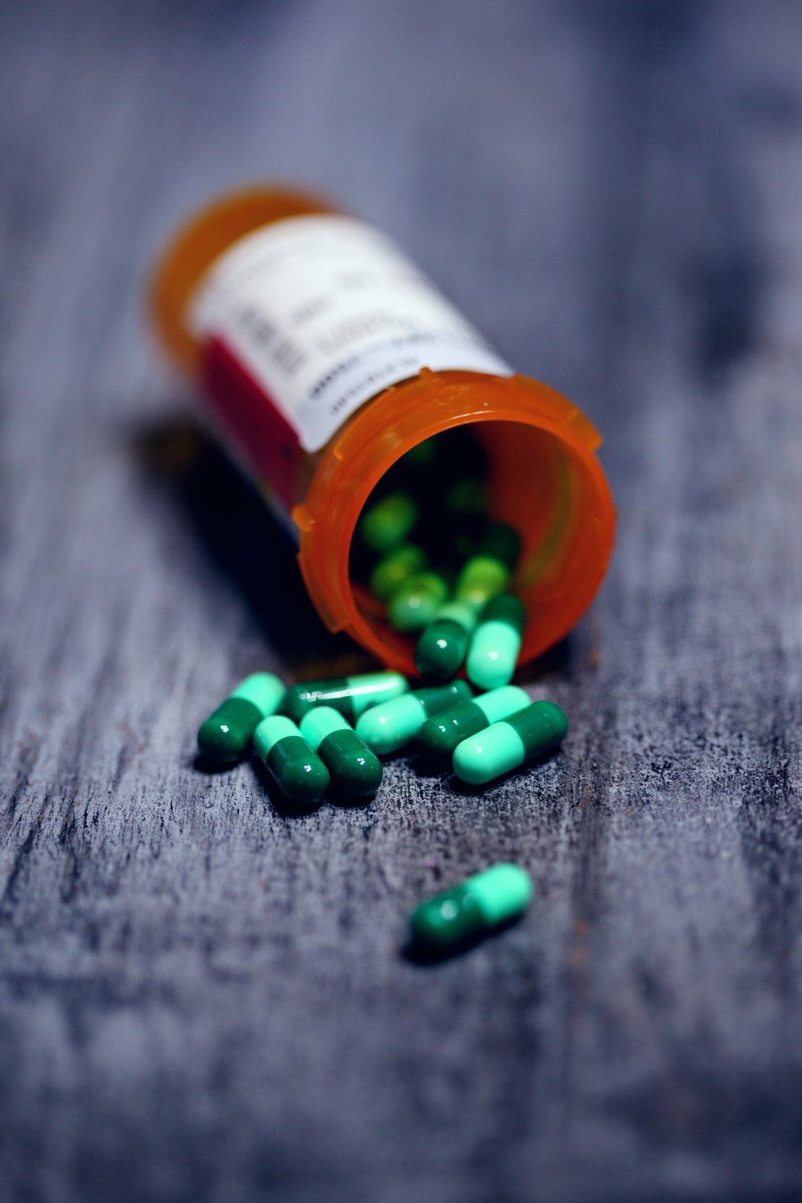 Lone Star Family Health Saving Money On Your Prescriptions Bottle of Prescription Pills Spilled on Wood Table